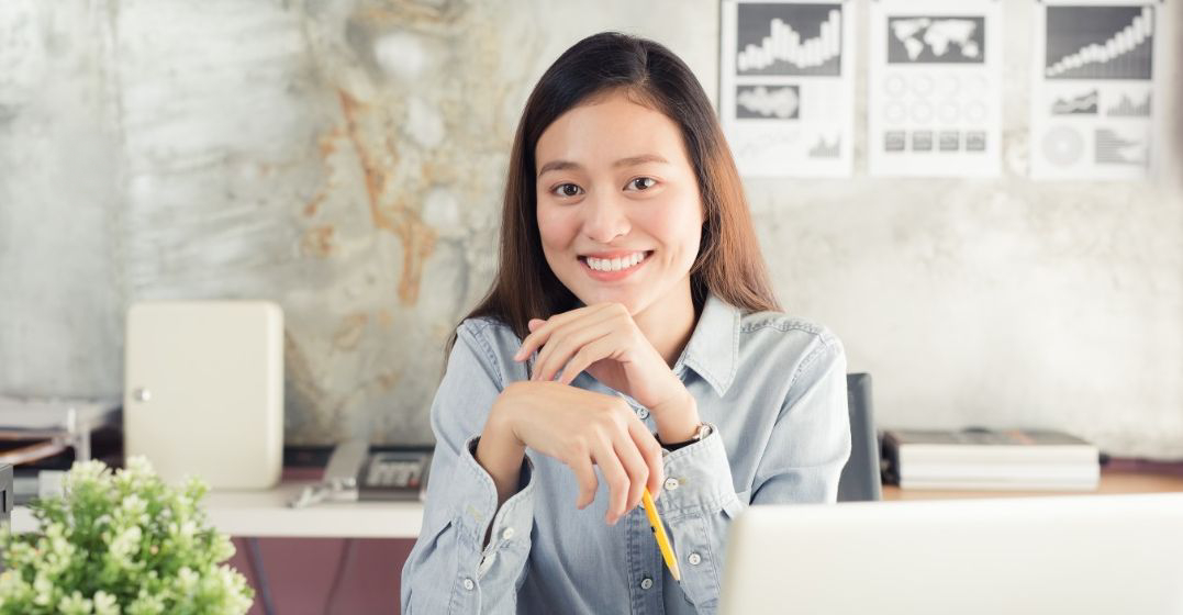 woman smiling as she is learning a language and it is boosting her mental health