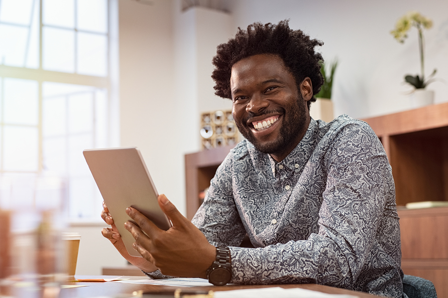 man smiley into camera and happy that he is learning a new language