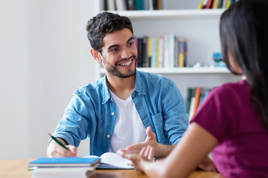Smart Spanish Male Student Preparing For Exam On Private Lesson