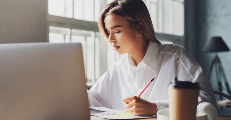 Girl,Sitting,Concentrated,At,Laptop,And,Studying,Remotely.,Student,Using laptop and learning useful phrases in English