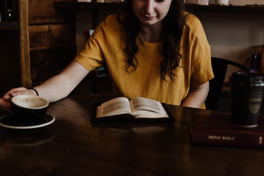 woman reading a book studying languages