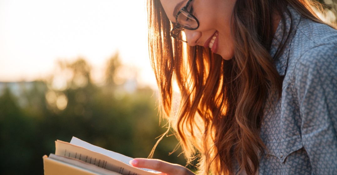 woman reading about the top 7 easiest languages to learn