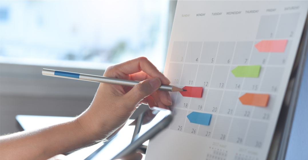 woman writing on the days of the week in English