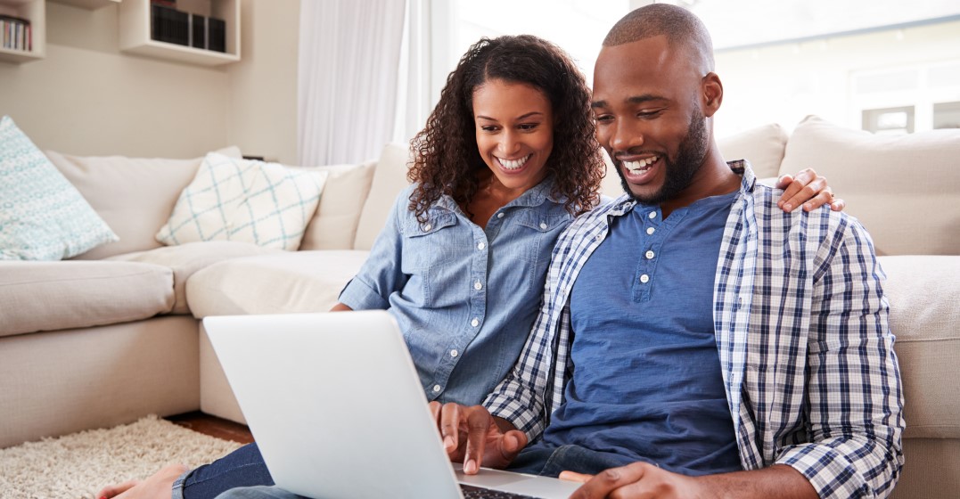 Couple looking at a laptop researching different ways to say I love you