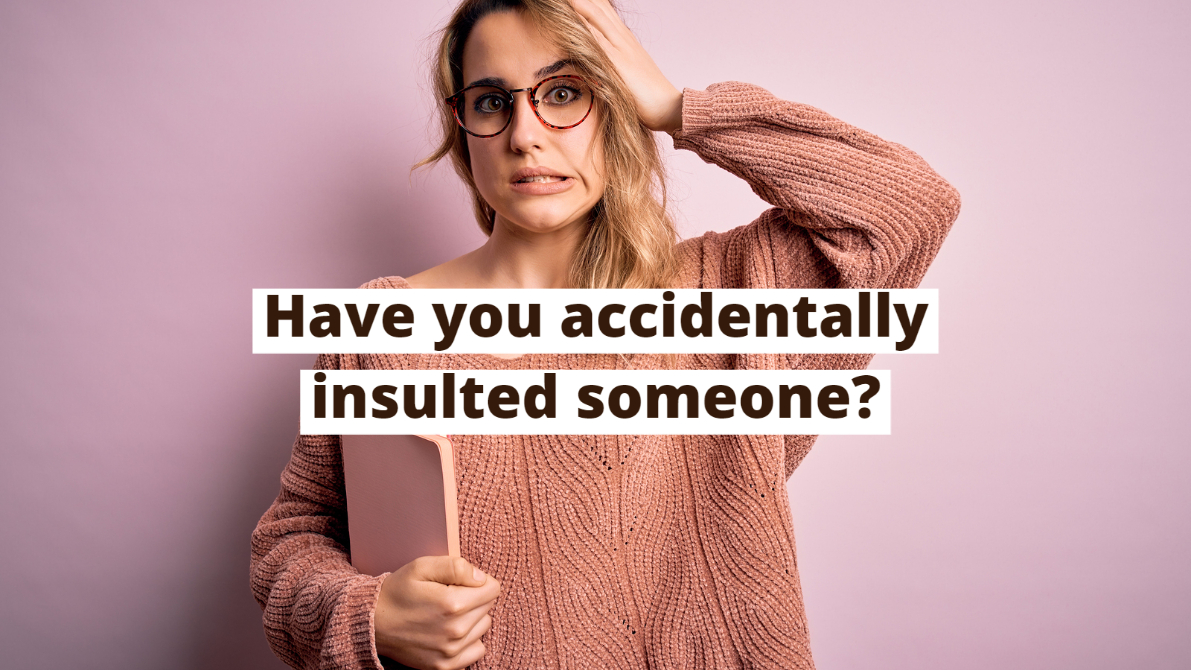 Woman looking ashamed about using disrespectful gestures in different cultures