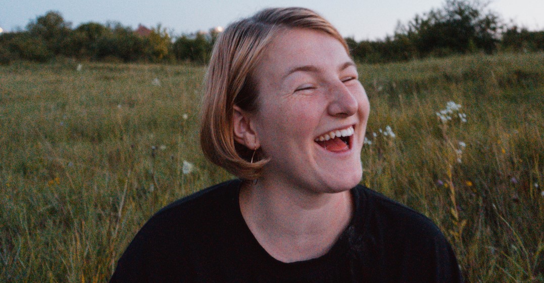smiling woman sharing the best ways to learn a language as an adult