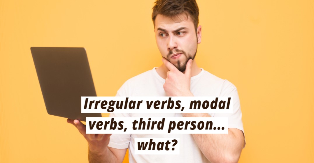 Man looking at a laptop frowning and wpndering about German verb conuugations