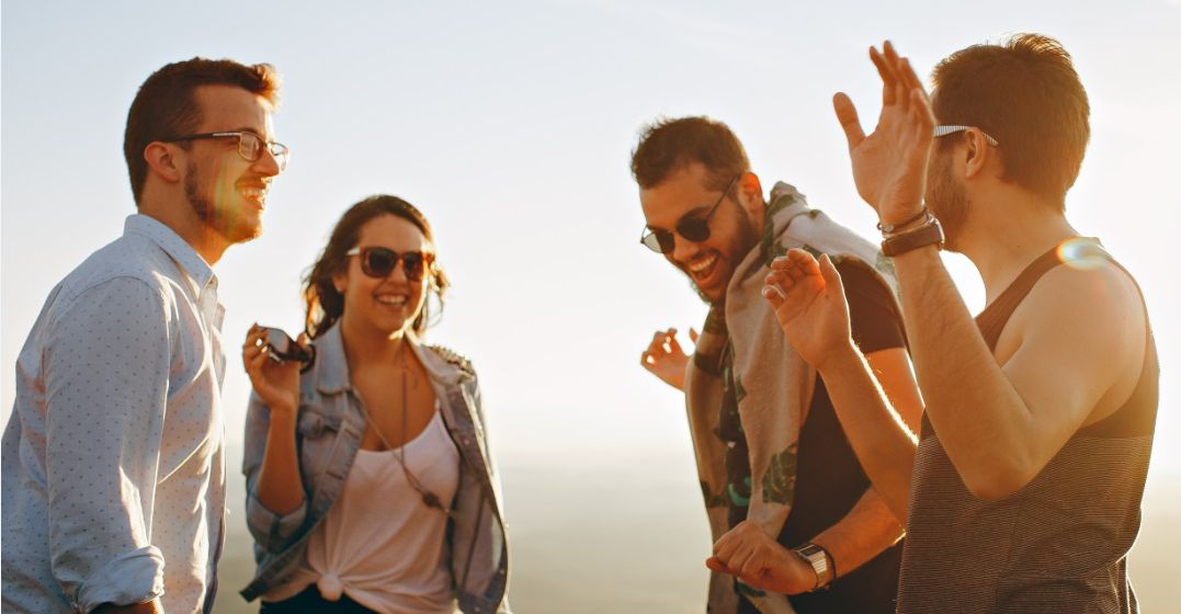 Group of cheerful people talking about their hobbies in French