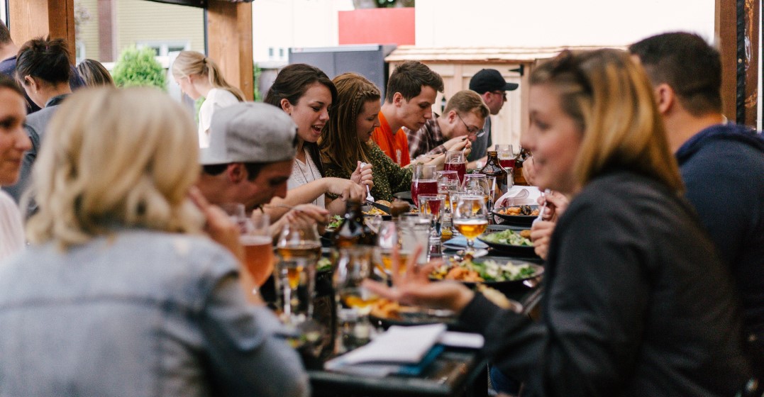 a group of friends in a spanish restaurant ordering and eating food
