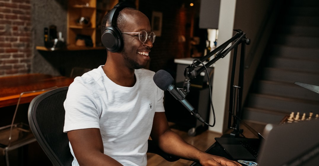 Smiling man recording one of the best podcasts to learn German