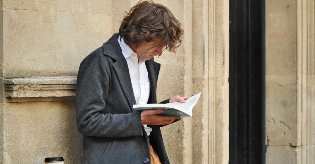 man reading about The pros and cons of learning a new language