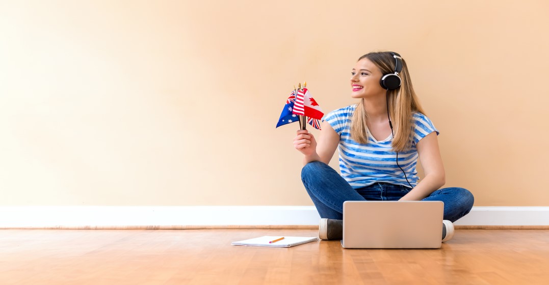 A young woman with headphones practicing the different accents from the UK
