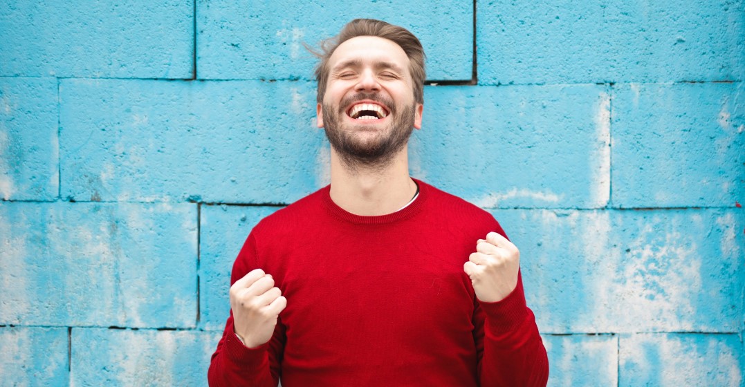 Happy man in red short particing how to express happiness in English