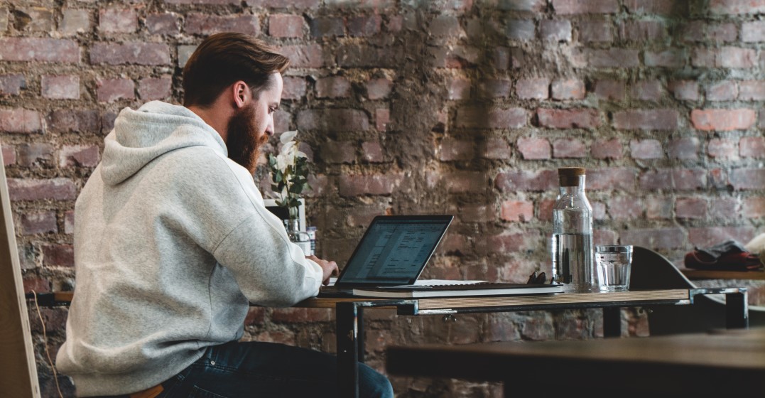 man working ina cafe as a digital nomad