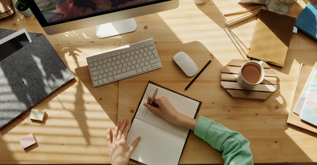 10 best languages to learn: person writing in a notebook