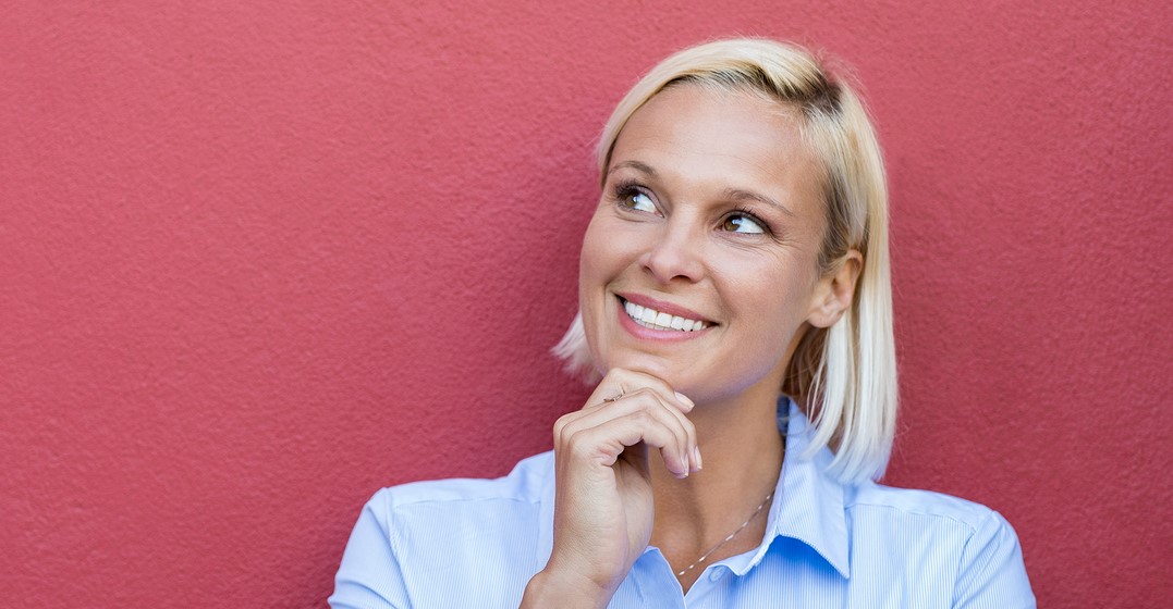 Smiling woman with a thinking face wonders about English suffixes