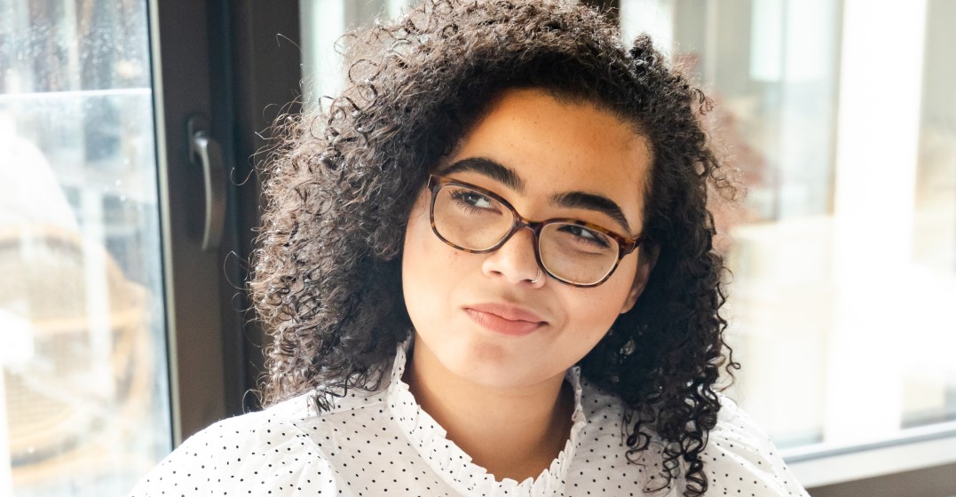 Young woman up close thinking about English language facts