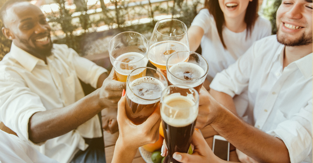 People clinking beer glasses, a German tradition