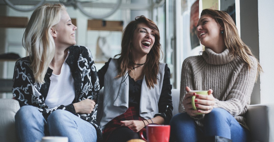 friends laughing together as they practise their british accent