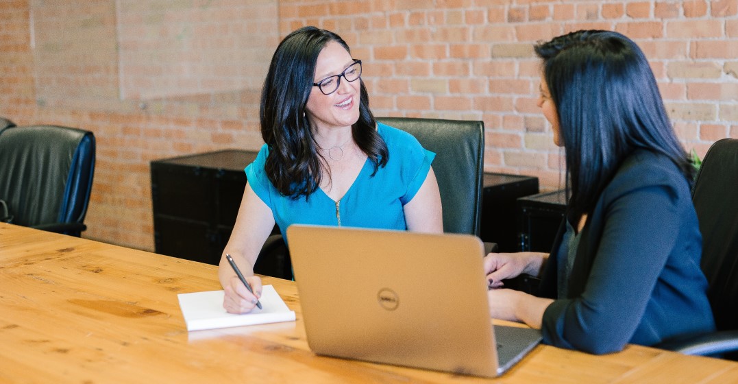 Two women discussing how to negotiate the salary of the candidate