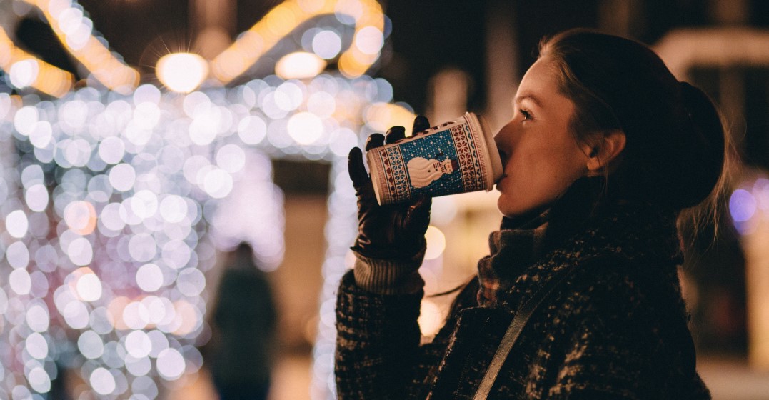 woman drinking hot chocolate and celebrating christmas