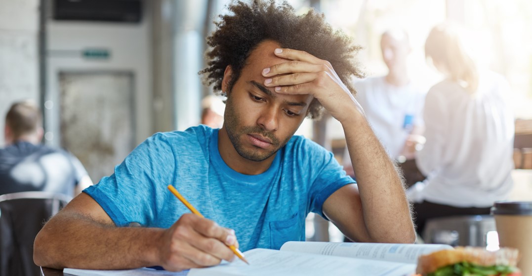 man studying basic Spanish verb conjugation