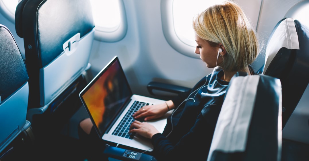 woman watching French youtube channels whilst on a flight