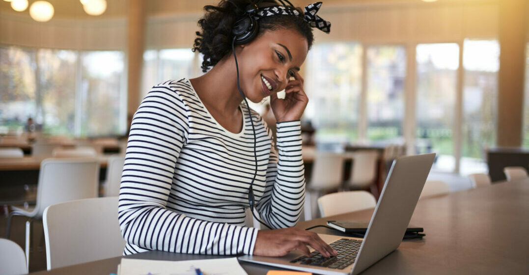 Smiling woman working on a laptop