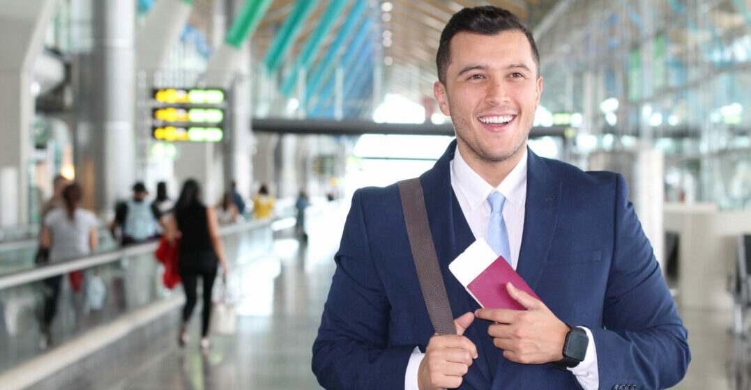 Businessman holding a passport in an airport