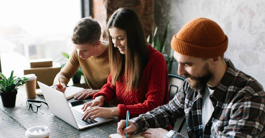 Trois étudiants avant des ordinateurs qui aprennent comment retenir une langue