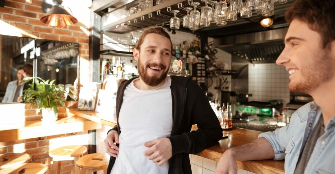 Two friends at a bar talking about how to learn German for ENglish speakers