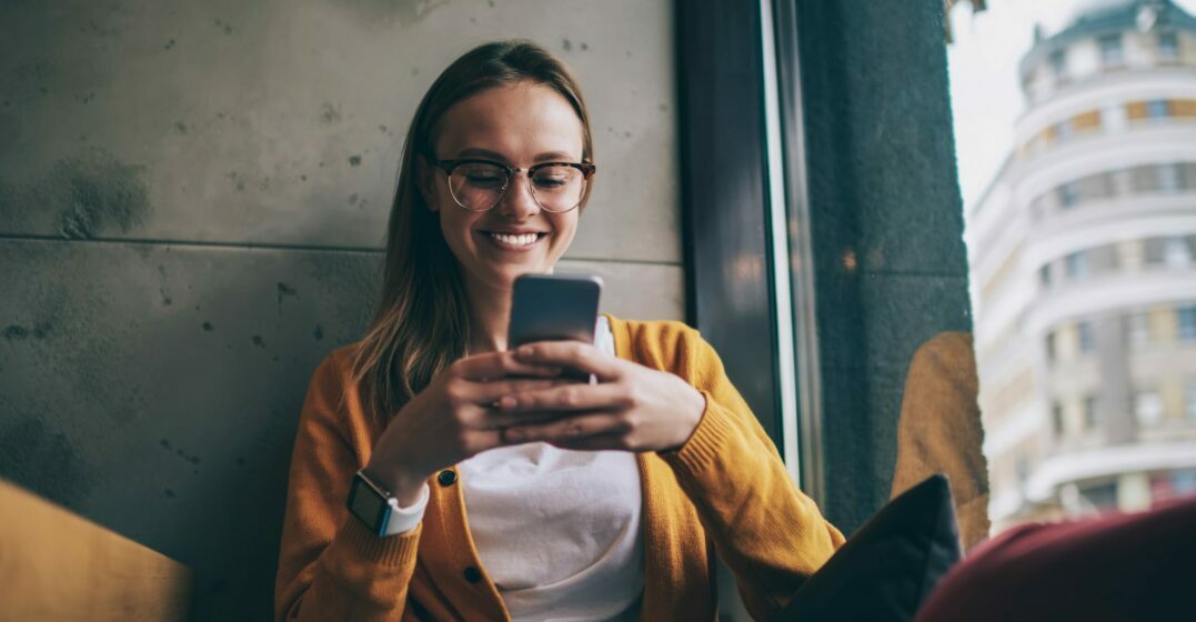 Smiling girl using one of the best french vocabulary apps