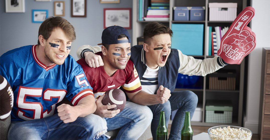 three men talking american football slang as they watch the superbowl