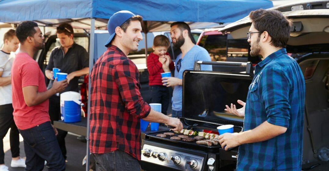 Two men having a barbecue at a tailgating party