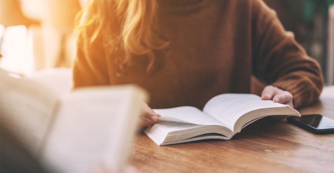 a girl reading german fairy tales on her book