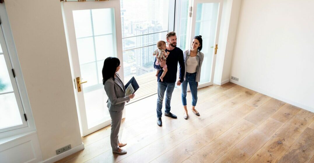 Family with estate agent learning how to buy a home in Germany