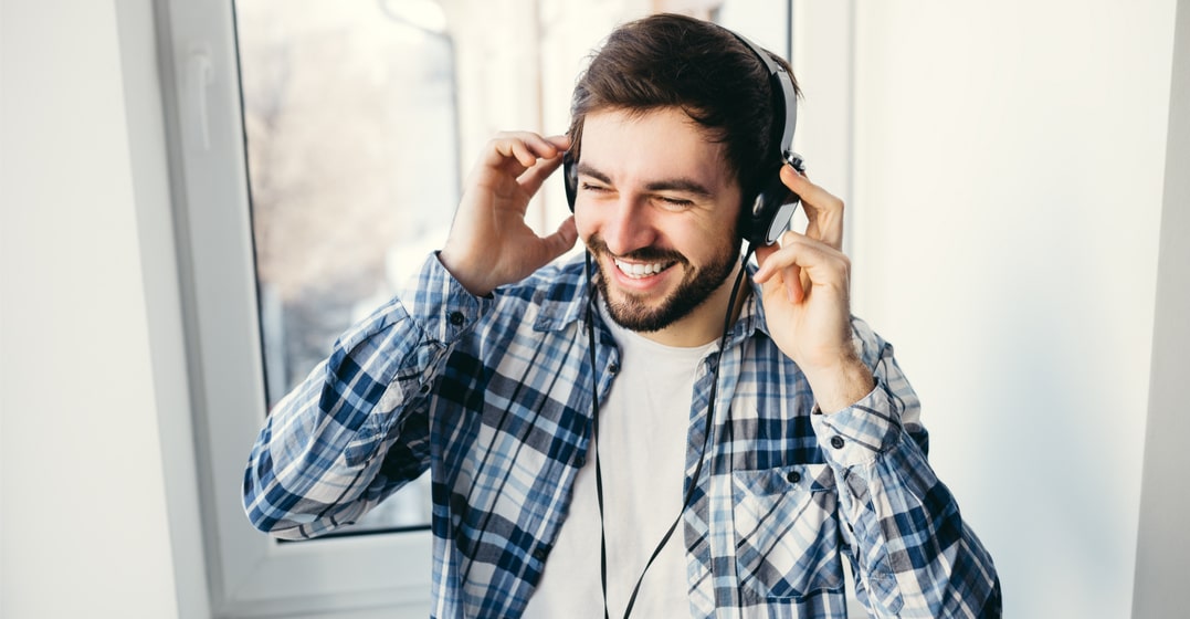 young man listening to popular songs in different languagse