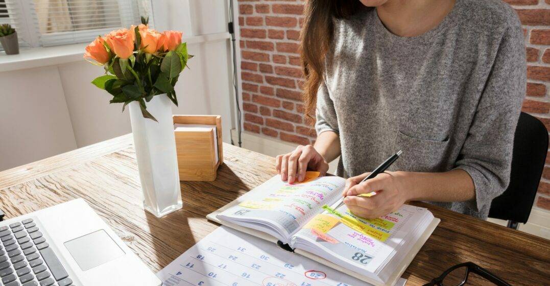 Woman at a desk looking at public holidays in Germany in her calendar