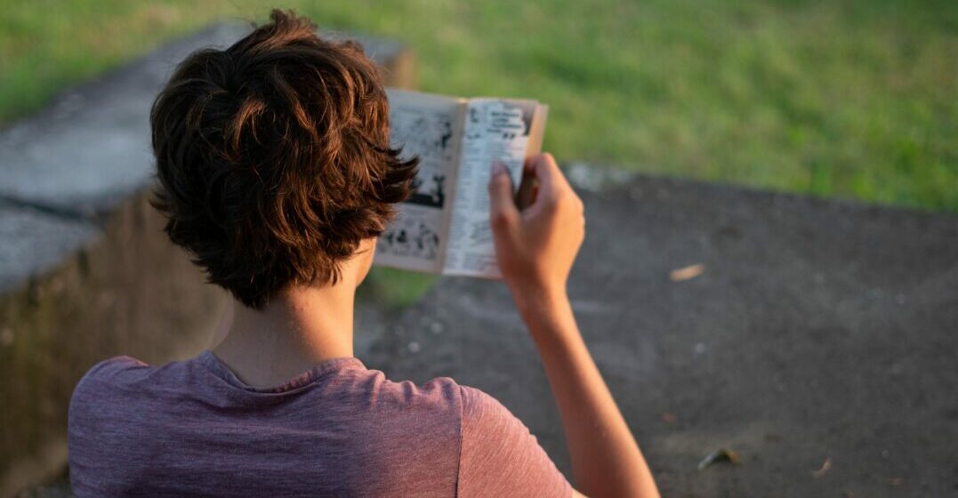 Boy reading French comic books