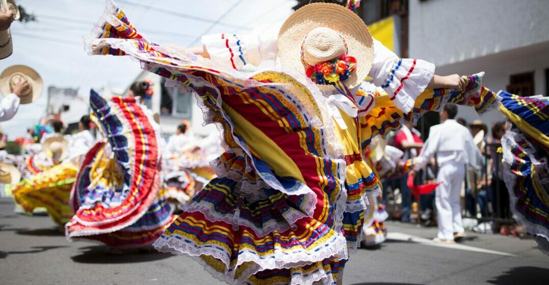 Woman dancing in a traditional Colombian outfit representing the language of Colombia