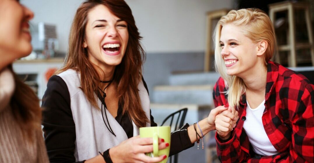 Two female freinds holding hands saying their congratulations in German