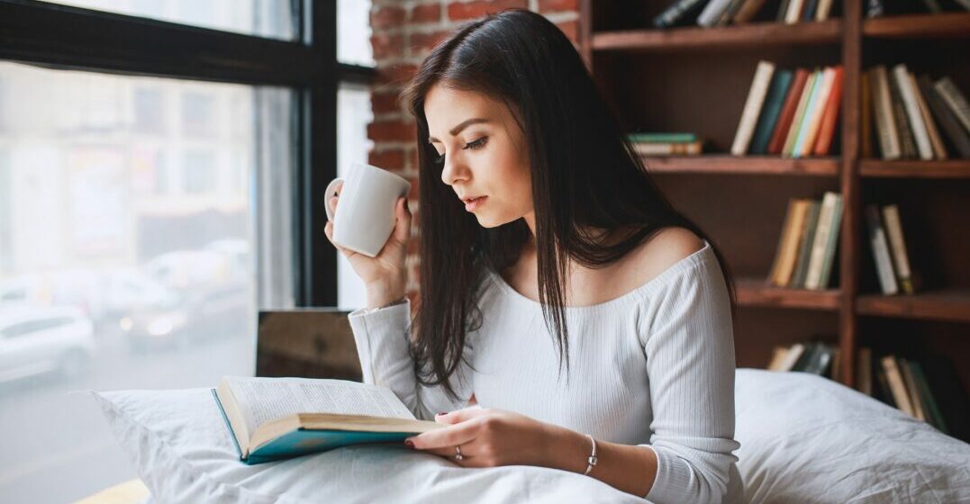 A woman reading one of the easiest books to learn English