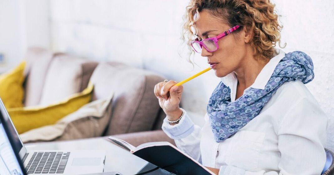 Woman with a notebook studying the indicative mood