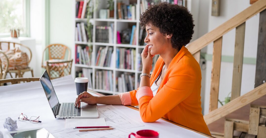 Young woman in front of her laptop studying the simple future tense in English