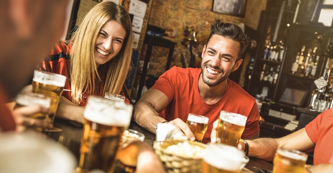 Friends around a table trying different types of German beer