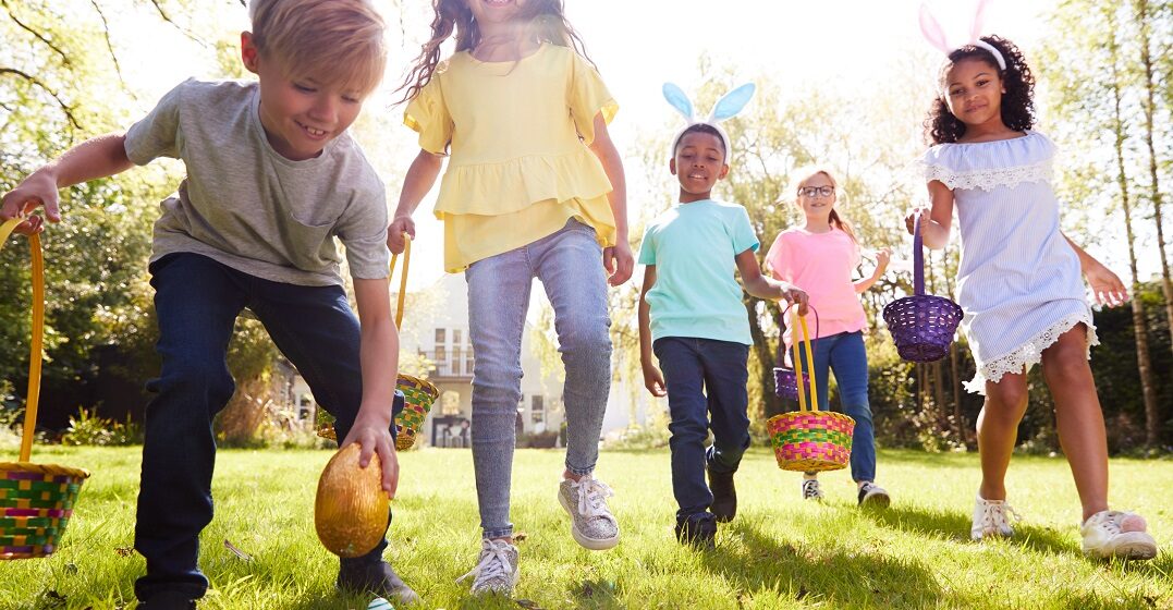 Children hunting for eggs having a happy easter in french