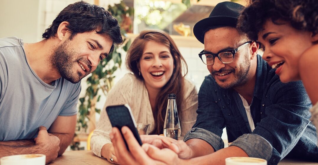 Group of friends learning German tongue twisters