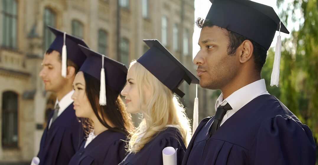 Graduate students listening to a graduation speech