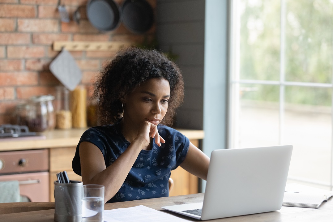 Young African woman sitting in front of a laptop reading about homophones