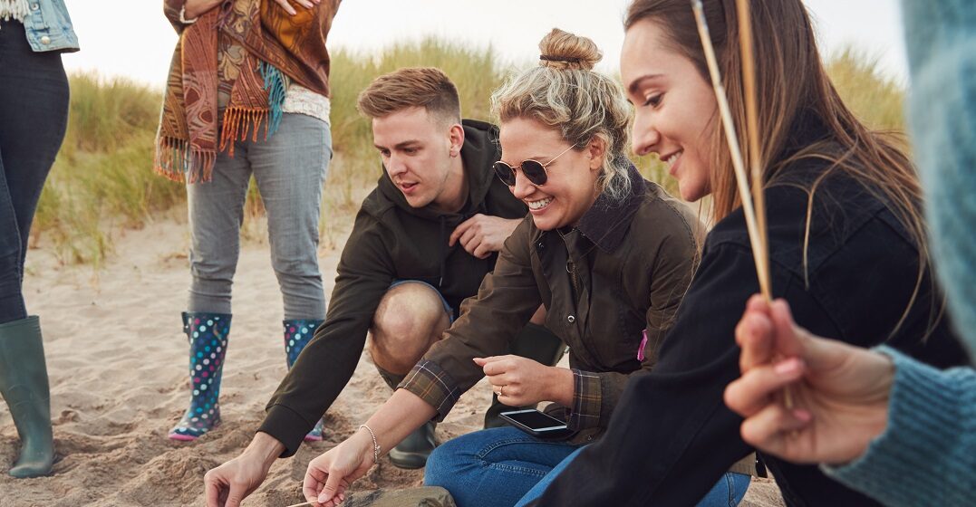 Group of friends by the beach speaking in the Welsh accent